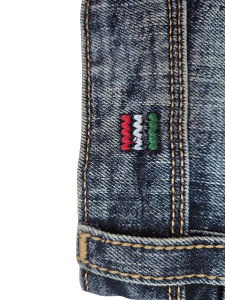 Close view of the embroidered tab at the hem